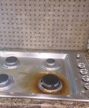 Dirty stove before professional deep cleaning service